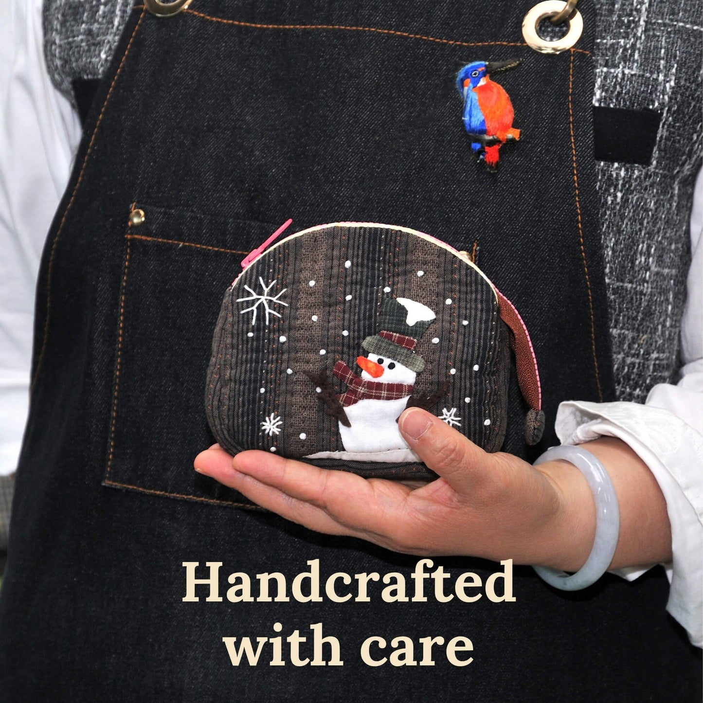 Artisan hands holding handmade quilted snowman coin purse showing palm-sized scale, handcrafted small batch construction ingriTAO